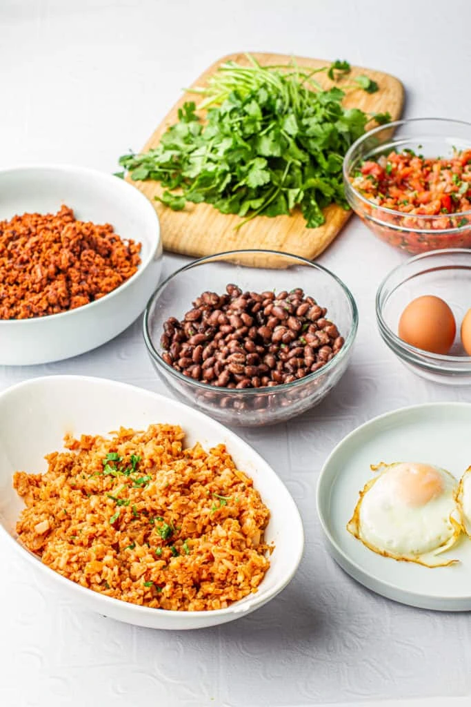 A vibrant array of fresh ingredients ready for assembling a breakfast burrito bowl