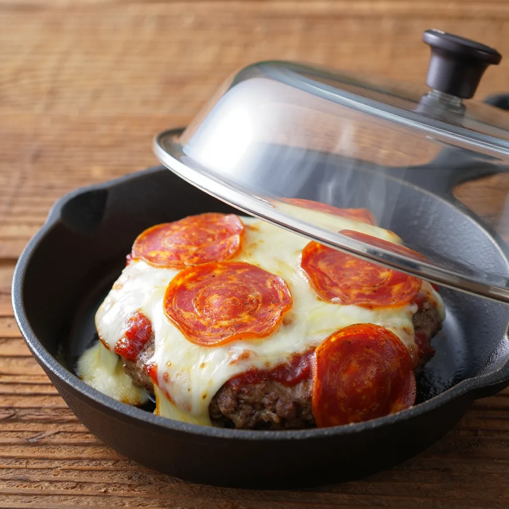 Pizza Burgers: Cheese Melting Under Lid Steam melting mozzarella over pepperoni on a pizza burger patty